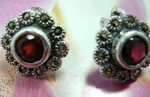 Multi mini marcasites stone forming flower  sterling silver earring with a rounded garnet stone embedded in middle             