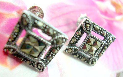 Multi mini marcasites stone forming flower  sterling silver earring with a rounded garnet stone embedded in middle             