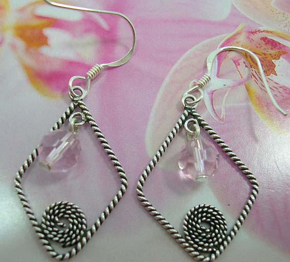 Twisted sterling silver open diamond shape French fish hook earwires  earring hanging a pink crystal and spiral pattern in the middle            